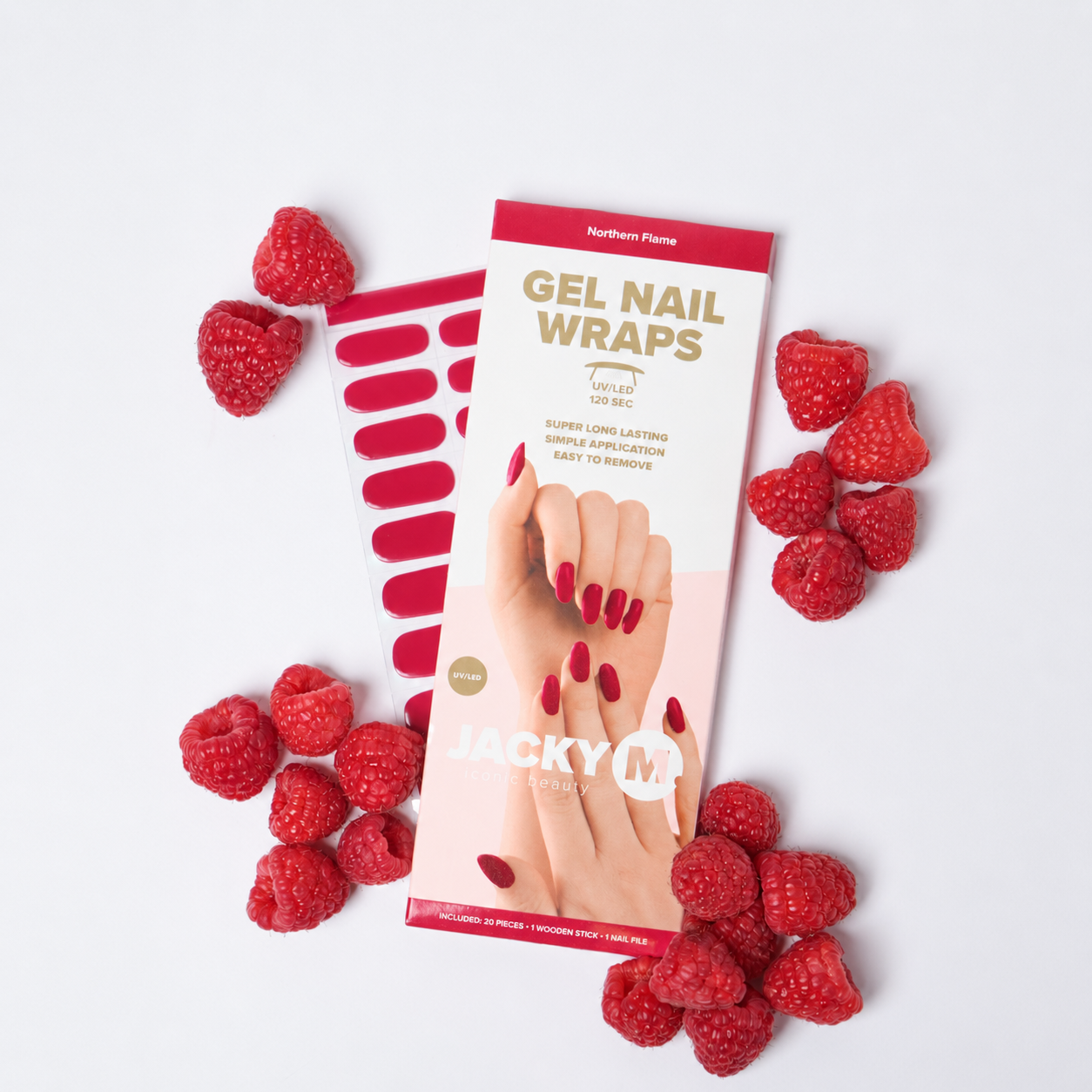 Pack of Jacky M Gel Nail Wraps with red berry-themed packaging, surrounded by fresh raspberries on a clean white background.